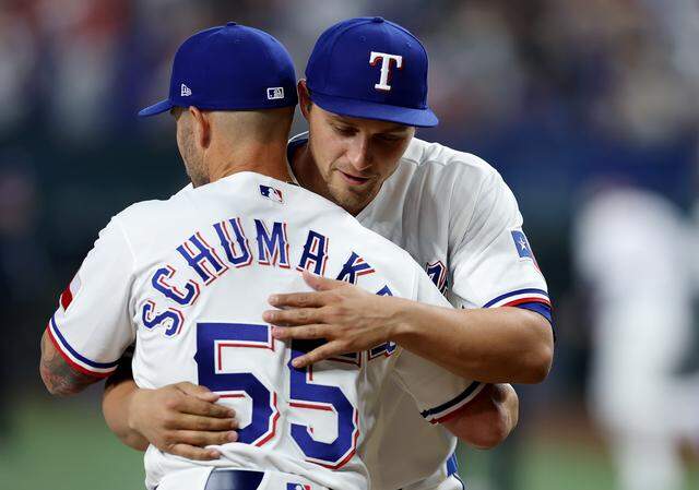 Texas Rangers shortstop Corey Seagar hugs manager Skip Schumaker prior to the home opener against the Cincinnati Reds on Friday, April 3, 2026.